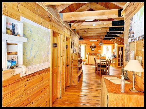 a room with wooden walls and a map on the wall at gite comme un accord in Saint Mathieu Du Parc
