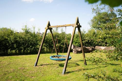 a swing set in a grassy field at Sedgewell Barn by Wigwam Holidays in Northallerton