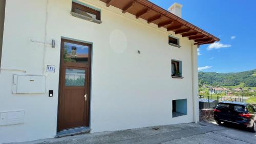 a house with a door and a car parked outside at Matxiku Aurre in Berástegui