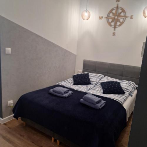 a bedroom with a bed with two towels on it at Apartamenty z basenem in Sarbinowo