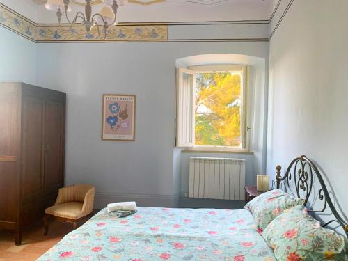 a bedroom with a bed and a window at Todi Villa San Martino in Todi
