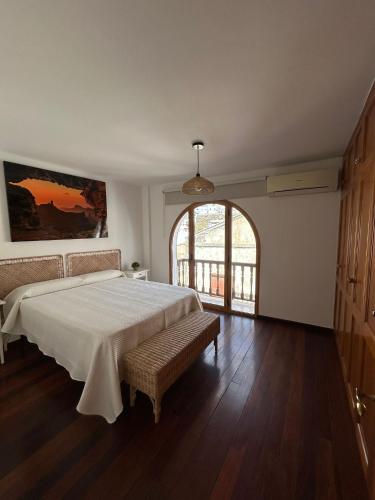 a bedroom with a large bed and a large window at Casa Salvador in Agaete
