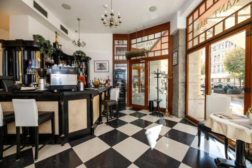 a bar in a restaurant with a checkered floor at Salvator Hotel in Karlovy Vary