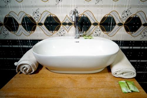 a white sink sitting on a wooden counter in a bathroom at Royal Adventure Jaisalmer Resort in Jaisalmer