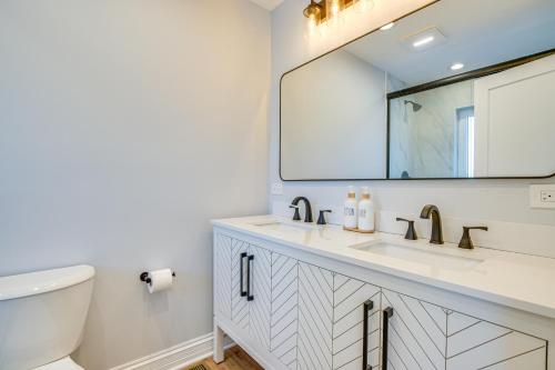 a bathroom with a sink and a mirror at 2 Mi to Northwestern Updated Home with Game Room! in Evanston