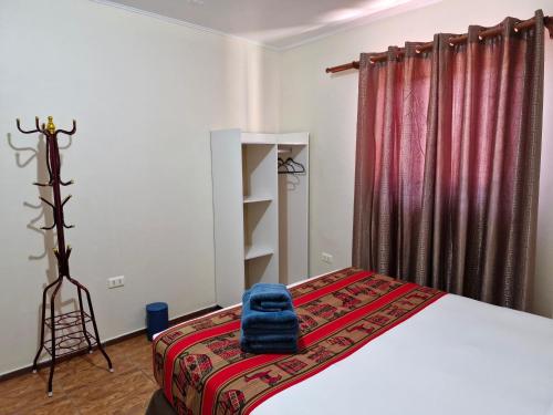 a bedroom with a bed with a red curtain at hostal casa talitha in San Pedro de Atacama