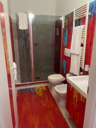 a colorful bathroom with a shower and a toilet at Rooms Of Love in Pavia