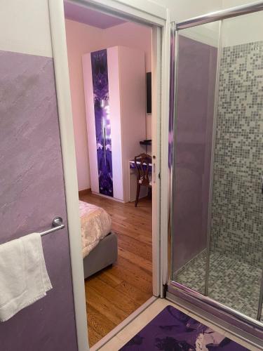 a bathroom with a shower with a glass door at Rooms Of Love in Pavia