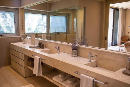 une salle de bain avec deux lavabos et un grand miroir dans l'établissement Finca Concepto Private Luxury At Alfa Crux, à San Carlos