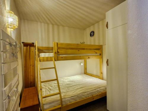 a bedroom with two bunk beds with a ladder at Appartement spacieux au centre, balcon, proche pistes, 6 pers - FR-1-425-229 in Arâches-la-Frasse
