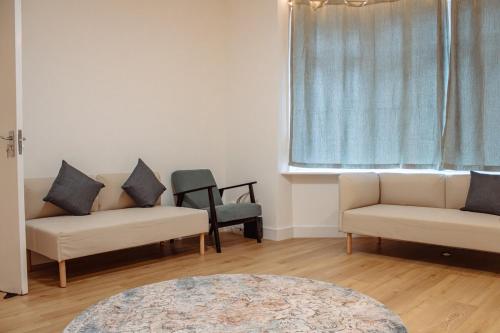 a living room with two couches and a window at Spacious 13-Bed in the Heart of Headingley in Headingley