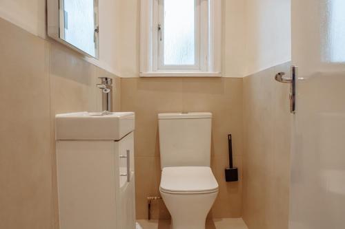 a small bathroom with a toilet and a sink at Spacious 13-Bed in the Heart of Headingley in Headingley