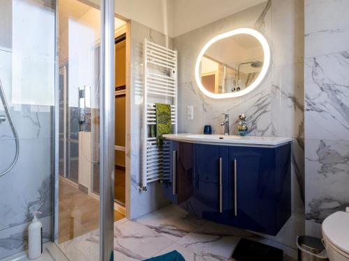 une salle de bain avec un lavabo bleu et un miroir dans l'établissement Maison spacieuse à 800m plage, jardin, animaux admis, parking, WiFi - FR-1-306-1294, à Saint-Brévin-les-Pins