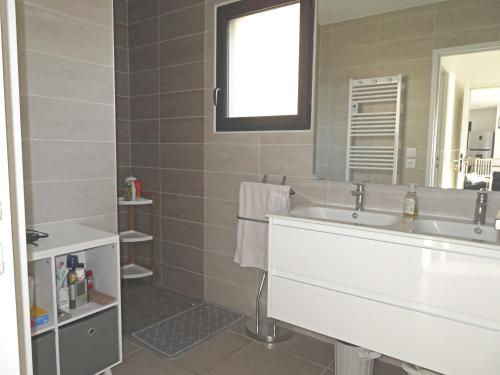 une salle de bain avec un lavabo blanc et un miroir dans l'établissement Villa moderne 5 pièces avec WIFI, climatisation, et parkings à Sète - FR-1-338-597, à Sète