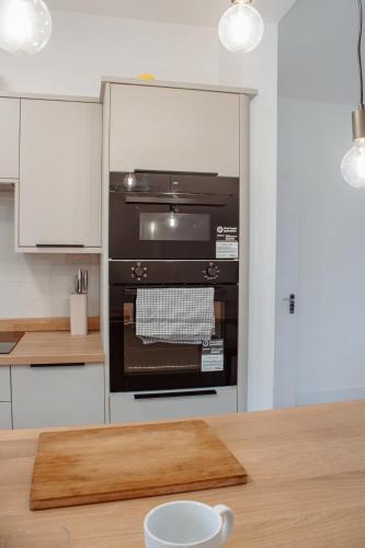 a kitchen with an oven and a wooden table at Spacious 13-Bed in the Heart of Headingley in Headingley