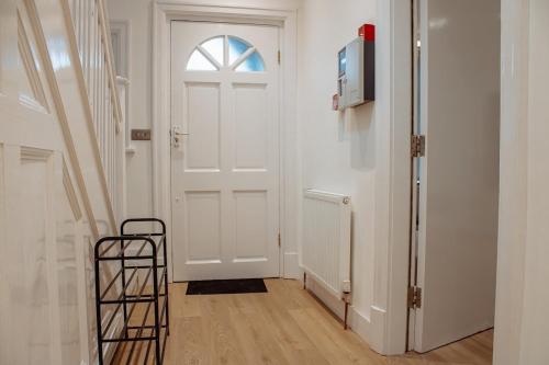 a room with a white door and a ladder at Spacious 13-Bed in the Heart of Headingley in Headingley