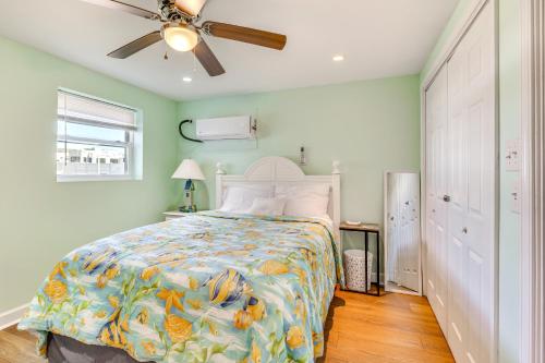 a bedroom with a bed and a ceiling fan at Walk to Shore Atlantic Beach Condo with Pool Access in Atlantic Beach
