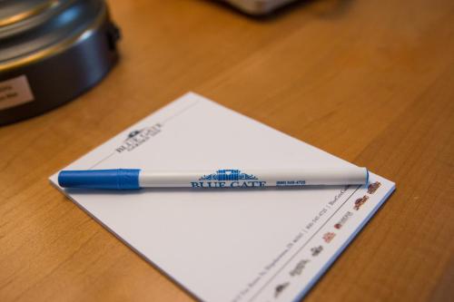 a blue pen sitting on top of a piece of paper at Blue Gate Garden Inn in Shipshewana