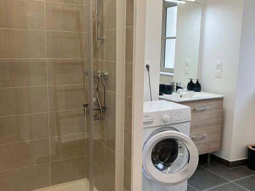 a bathroom with a washing machine and a shower at Appartement Neuf avec Terrasse au Coeur de Le Palais - FR-1-418-258 in Le Palais