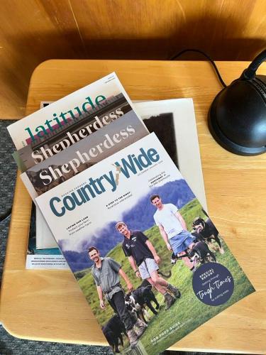 a magazine sitting on top of a wooden table at Southland Farming Retreat in Gore