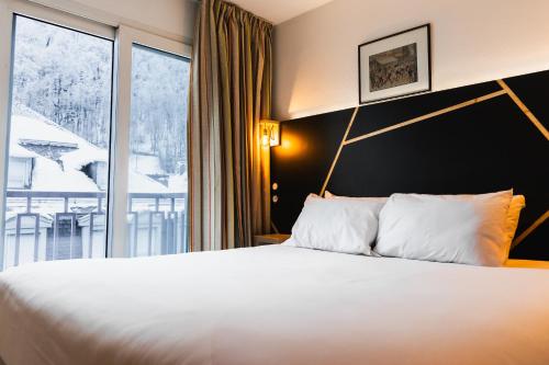 Katil atau katil-katil dalam bilik di Garden & City Cauterets Balneo