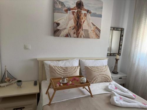 a bedroom with a bed with a table on it at Emerald Luxury Apartments in Limenas