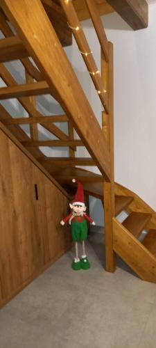 a statue of a elf standing under a bed at Biały Domek Świerczek in Słopnice