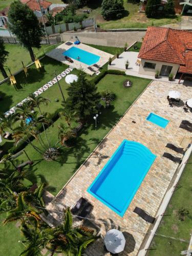 an overhead view of two swimming pools in a yard at Pousada Flores do Campo in Águas de Lindóia