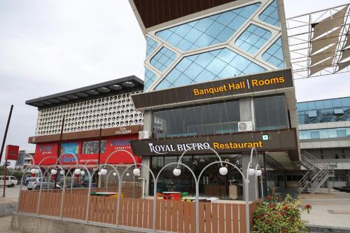 a building with a fence in front of it at Hotel Royal Bistro in Mehsāna