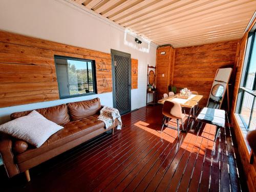 a living room with a couch and a table at Clare Cottage with 3 King Suites in Clare