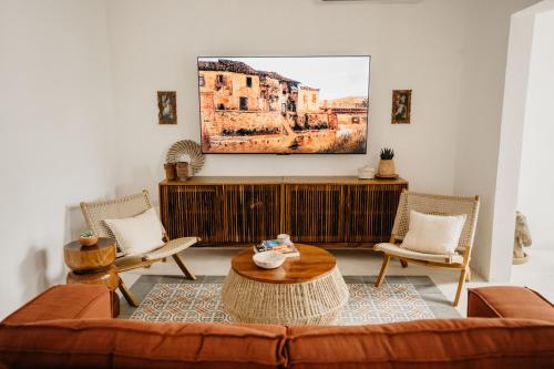 a living room with a couch and a table at Wild Valladolid 3BR Oasis w Pool & Yoga Palapa in Valladolid