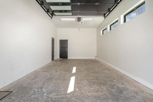 an empty room with white walls and a concrete floor at Phillips Apt in Matthews
