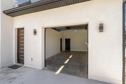 an open garage door of a white building at Phillips Apt in Matthews