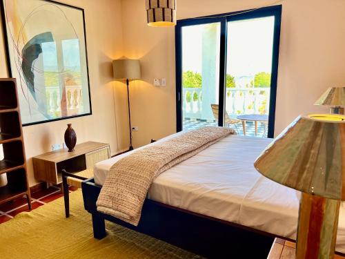 a bedroom with a bed and a large window at Hotel Villa Toti in Santa Veronica