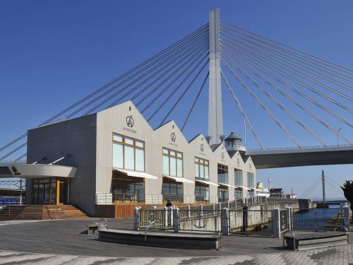a large building with a bridge in the background at APA Hotel Aomori Eki Kenchodori in Aomori
