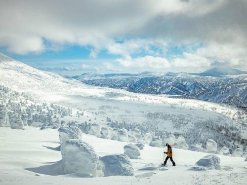 a person is skiing down a snow covered mountain at APA Hotel Aomori Eki Kenchodori in Aomori
