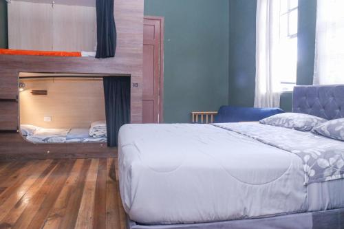 a bedroom with a bed and a bunk bed at Blue House Youth Hostel in Quito