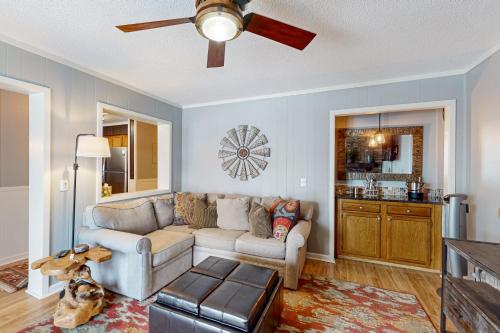 a living room with a couch and a ceiling fan at Pinnacle Inn in Beech Mountain