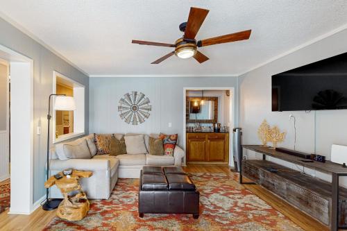 a living room with a couch and a ceiling fan at Pinnacle Inn in Beech Mountain