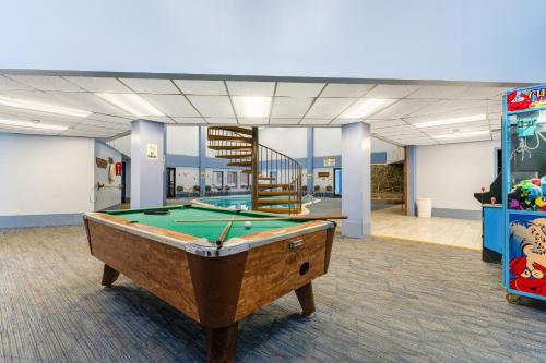 a room with a pool table and a staircase at Pinnacle Inn in Beech Mountain