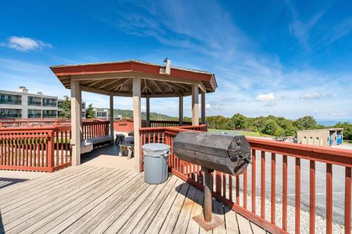 a wooden deck with a gazebo and a trash can at Pinnacle Inn in Beech Mountain