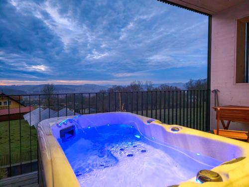 a jacuzzi tub on a balcony with a view at Stock & Stein Lodges in Bad Gleichenberg
