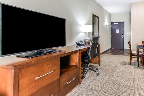 a television on a desk in a hotel room at Comfort Suites West Omaha in Omaha