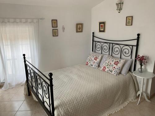 a bedroom with a black bed with two pillows at La Casa di Vale in Marano Equo