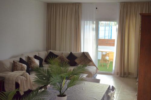 a living room with a couch and a table at Villa Mónica by Mirador de Sotavento Apartments in Cardón