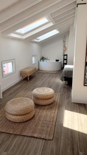 a large room with two circular stools on the floor at Láurea Ecocasona in Oreña