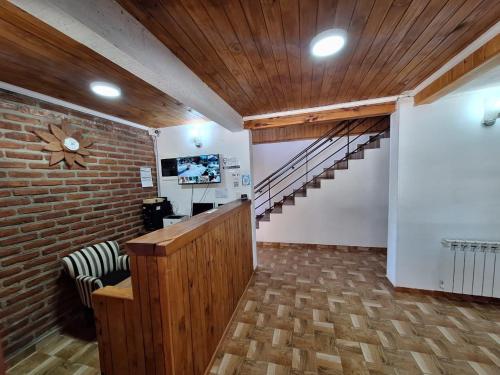 a room with a staircase and a brick wall at B&B Don Ciro in Villa La Angostura