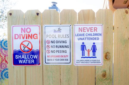 a bunch of signs on a wooden fence at 6S Hideout Houston in Cypress