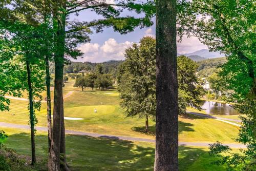 a view of a golf course through the trees at Fairway Gem at Spruce Pine in Spruce Pine