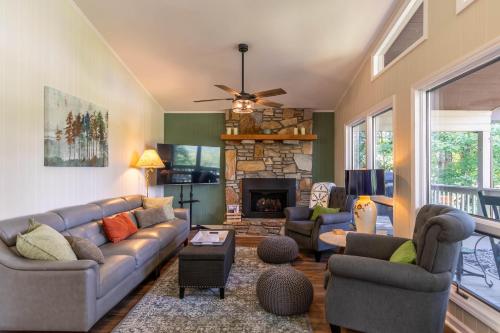 a living room with a couch and a fireplace at Fairway Gem at Spruce Pine in Spruce Pine